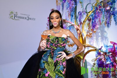 Winnie Harlow in front of the Perrier-Jouet tree designed by Bethan Laura Wood